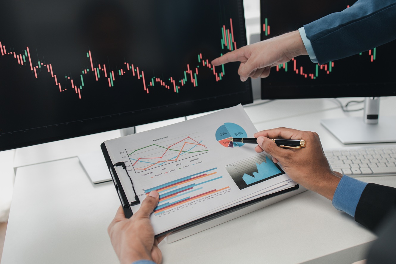 businessmen analyzing stock market graphs