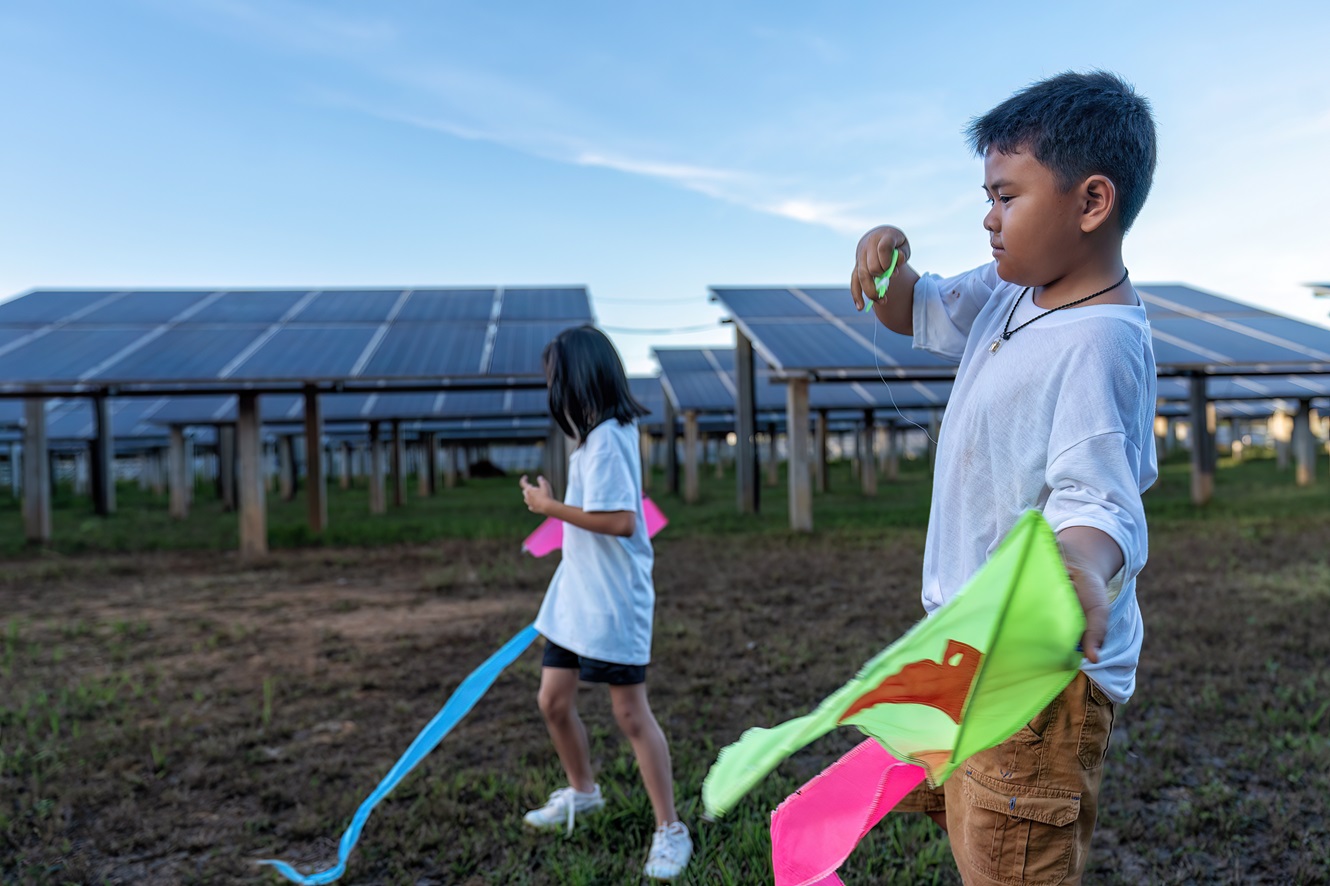 filipino kids playing around a solar farm