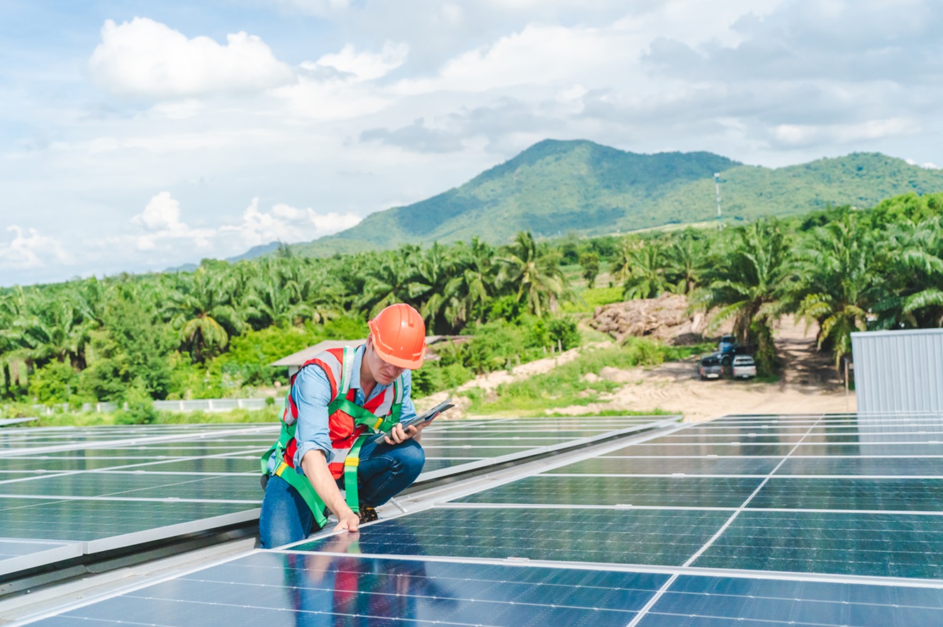 focused professional engineer installing solar panels